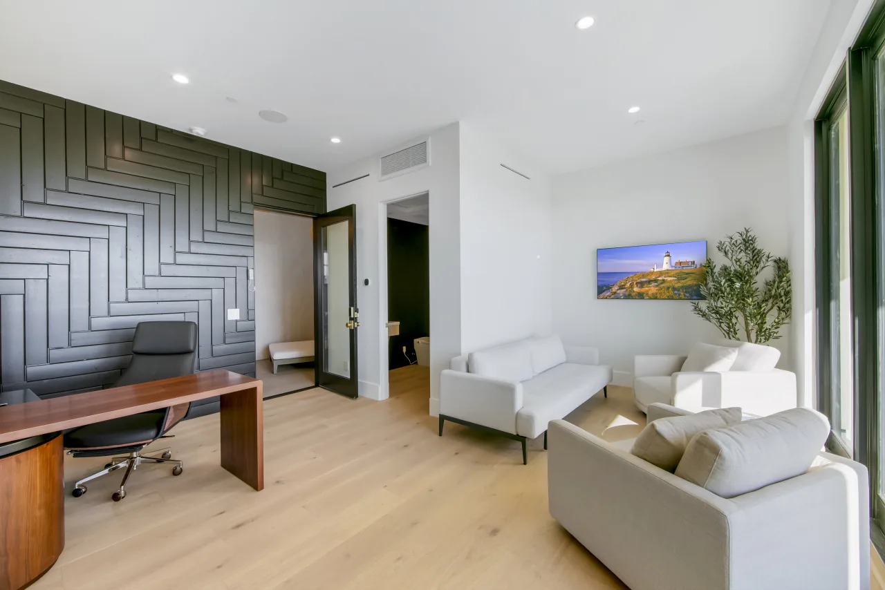 Office with dark geometric wall paneling